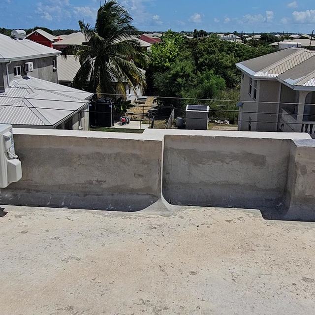 Outdoor unit on a boundary wall