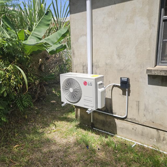 Outdoor AC unit beside a house